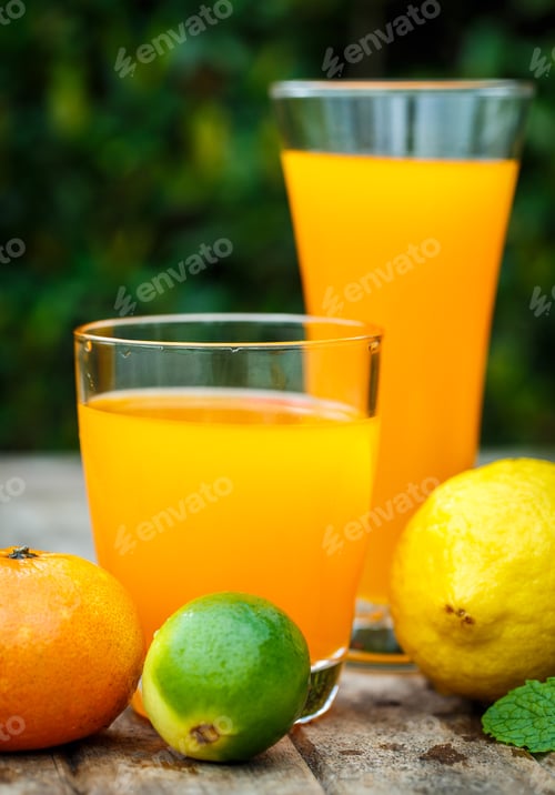 Preview: Orange juice with lemon, lime and mint on a wooden board