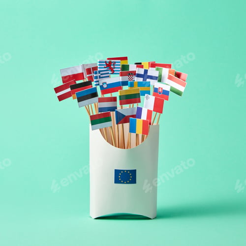Preview: Set of different paper flags in cardboard box decorated with EU sign on green background with copy