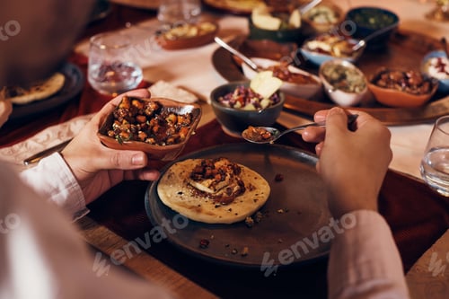 Preview: Close-up of Muslim man having Taboon bread with tofu and salad during Iftar meal on Ramadan at home.