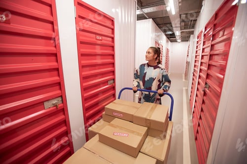 Preview: Woman Looking for Door of Storage Unit