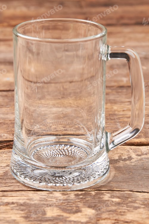 Preview: Empty beer mug isolated on wooden background