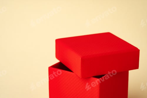 Preview: Red jewelry box on beige background close up