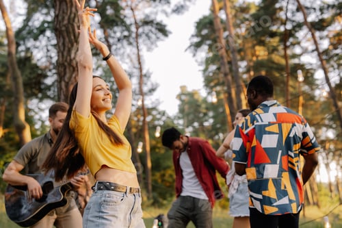 Preview: Multiracial group of people, beautiful hipster woman dancing on the background of friends having fun