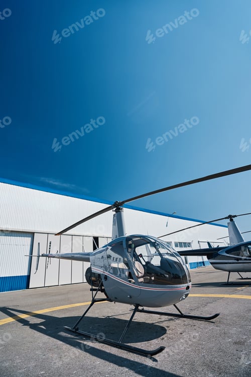 Preview: Two civilian helicopters parked on landing pad