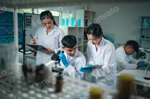 Preview: Medical research teamwork in laboratory using microscope and blood test tubes for DNA analysis