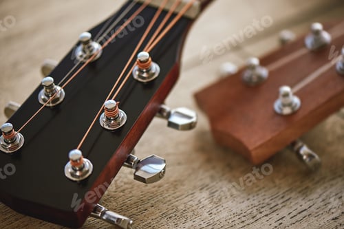 Preview: Sound adjusting. Close up photo of guitar necks with tuning keys for adjusting strings against