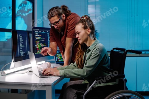 Preview: Young man and his colleague with disability discussing points of presentation