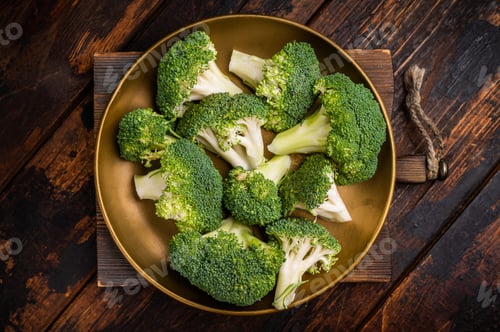 Preview: Fresh broccoli cabbage pieces on a plate. wooden background. top view