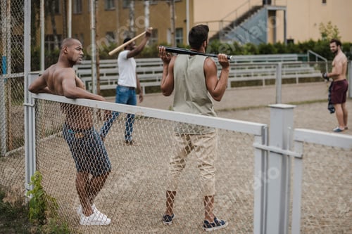 Preview: group of young multiethnic male baseball players on court