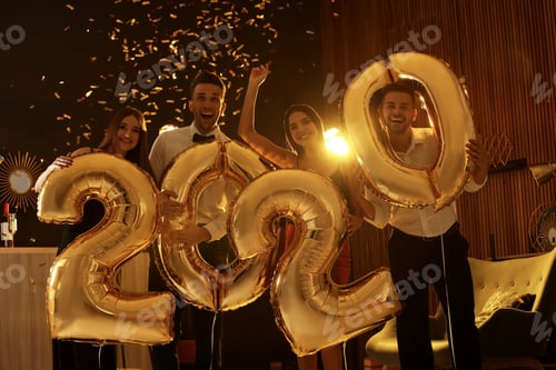 Preview: Young people with golden 2020 balloons celebrating New Year in club