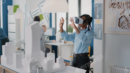 Preview: Architect using vr glasses to design building model and construction layout