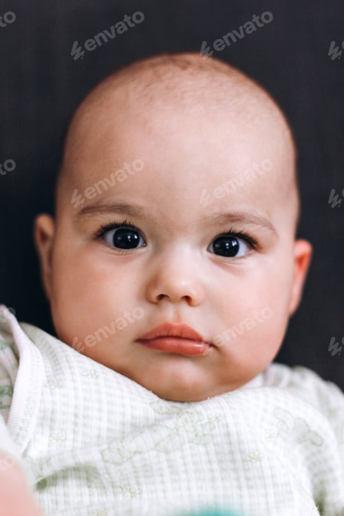 Preview: Sweet serious baby with big eyes and chubby cheeks