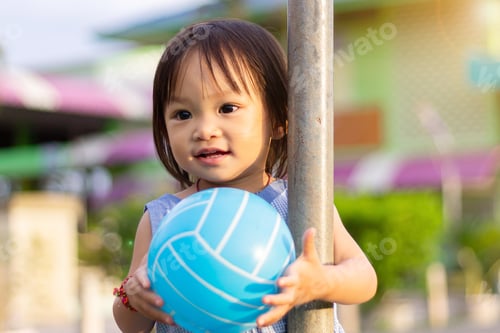 Preview: Happy Asian baby child girl playing ball toys at the field playground