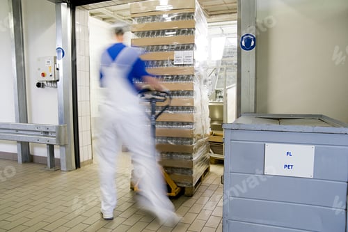 Preview: Worker swiftly moving a pallet in a blur of motion through a warehouse