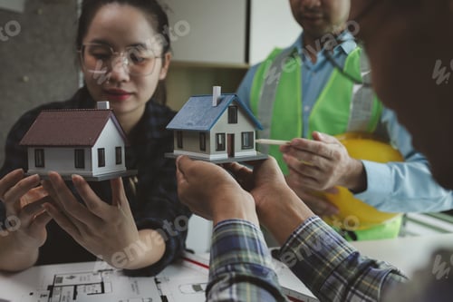 Preview: A team of engineers meets in the office to analyze the design structure to ensure it meets the clien