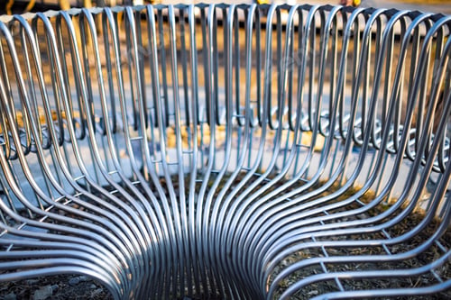 Preview: Close-up street bench metal pipes arranged parallel
