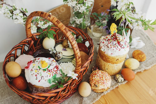 Preview: Easter food, easter eggs, beets, cheese, butter, ham, Easter bread and basket on rustic table