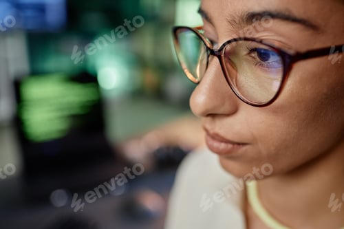 Preview: Close up of Middle Eastern Female Programmer Wearing Glasses while Working in Office