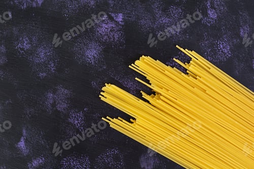 Preview: Dry pasta background. Spaghetti pasta on dark background. Flat lay. Top view.