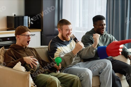 Preview: Group of Friends Watching Game on TV Holding Sports Fan Accessories