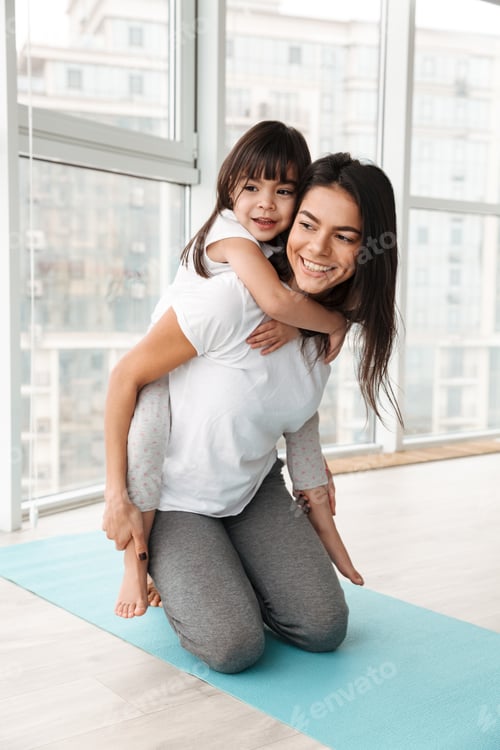 Preview: Photo of cheerful family mother and child having fun, while woma