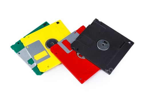 Preview: Collection of old floppy disks in multiple colors on a white background