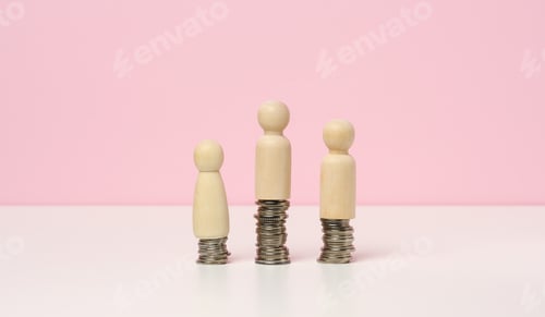 Preview: Stack of metal coins and wooden figures of men on a white table.