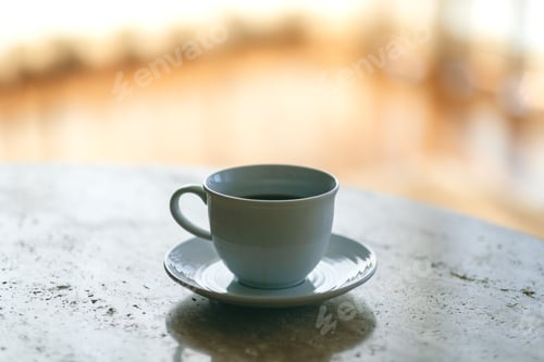 Preview: A white mug of hot coffee on the table