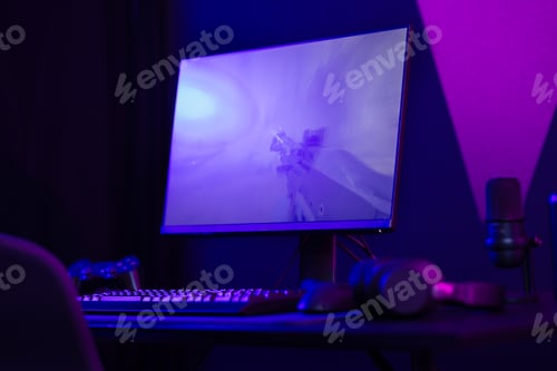 Preview: Professional and colorful e-sport gamer room with first-person shooter online video game on computer