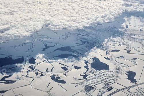 Preview: Aerial cloudscape view over clouds top to snow covered rivers, roads, cities and fields, winter air