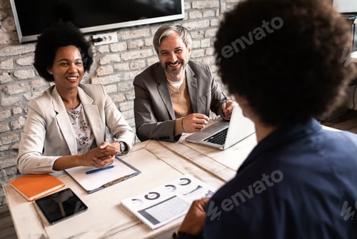 Preview: Business recruiters talking with candidate during job interview.