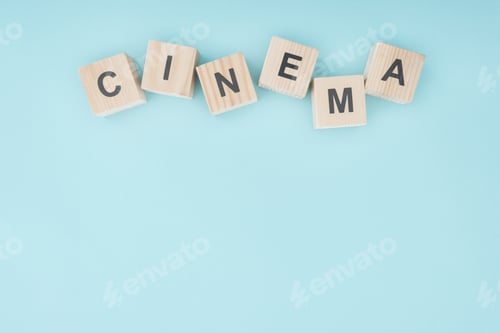 Preview: wooden cubes with"cinema" lettering isolated on blue