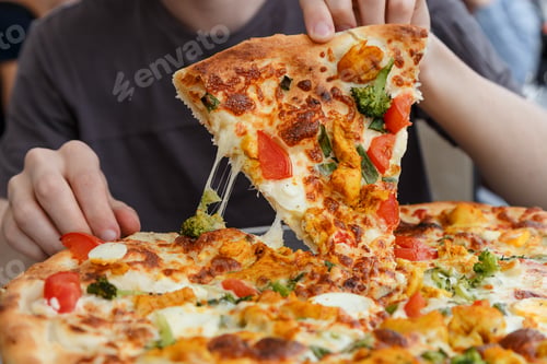 Preview: a man takes a slice of pizza closeup