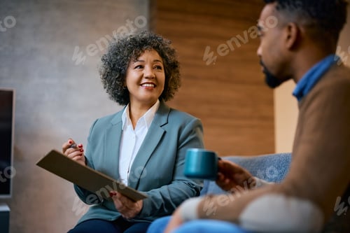Preview: Happy financial advisor having a meeting with her client in the office.