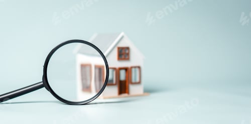 Preview: A magnifying glass is on a table next to a house. The house is white and has a brown roof.