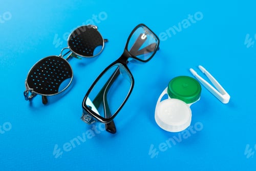 Preview: Pinhole glasses, lenses with container and glasses for sight. Medical concept.