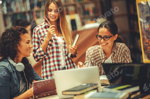 Preview: Group of female students study in the college library.