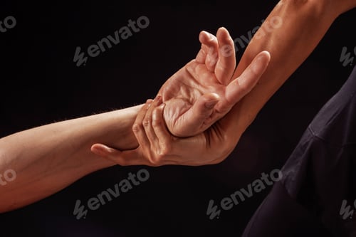 Preview: Therapist applies hand and wrist stretch technique on client during rehabilitation session.