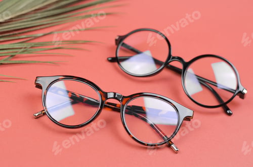 Preview: Stylish women's glasses on a colored background with palm leaves