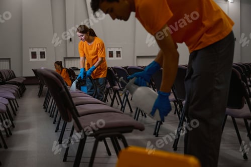 Preview: Three janitors performing great teamwork with disinfecting chairs
