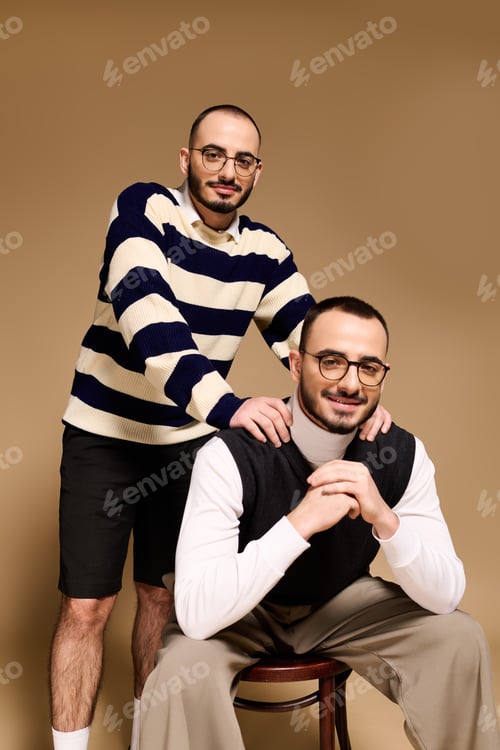 Preview: Stylish twin brothers posing together, showcasing modern fashion trends in a studio setting