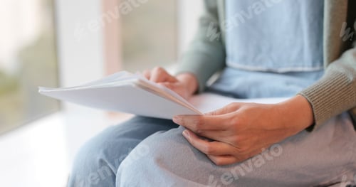 Preview: Student reading note on paper at school