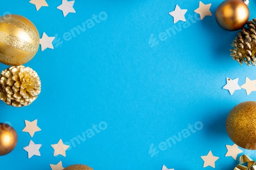 Preview: Image of christmas decorations with stars, baubles and copy space on blue background