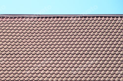 Preview: A fragment of a roof from a metal tile of dark red color. Quality Roofing