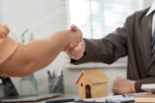 Preview: Successful Real Estate Deal Handshake Between Agent and Client