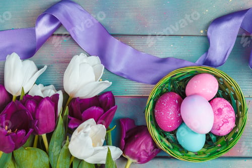 Preview: Easter eggs with tulips on blue wooden background