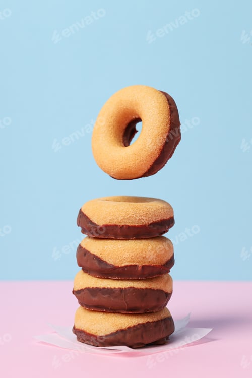 Preview: Chocolate donuts on paper on blue background