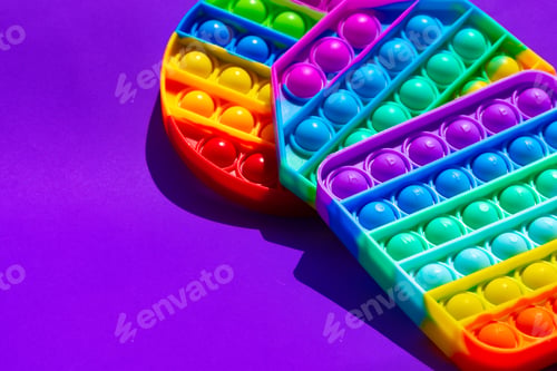 Preview: Colorful antistress pop it toy on purple background