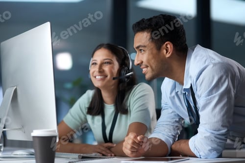 Preview: Shot of a young man and woman using a computer while working in a call centre