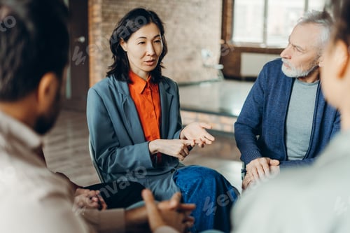 Preview: Asian businesswoman leading a team meeting in a modern office